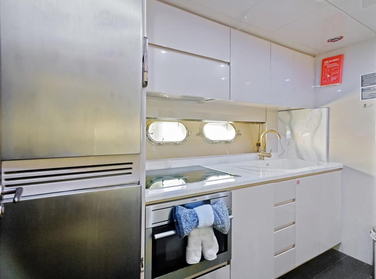 a kitchen with white cabinets aboard DREAM ON Yacht for Sale