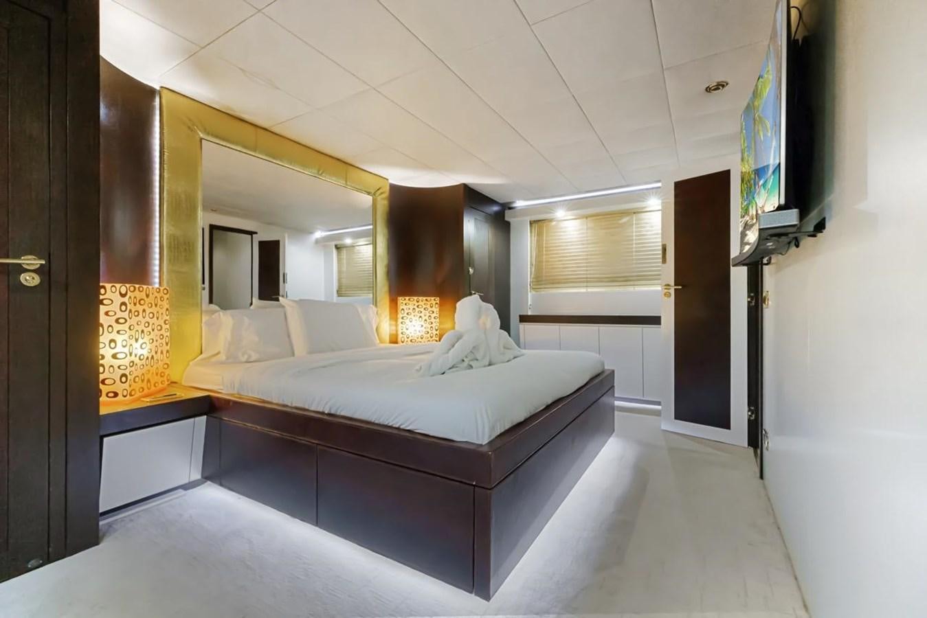 a bedroom with a bed and a television aboard DREAM ON Yacht for Sale