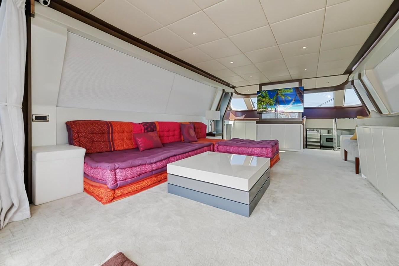 a living room with a purple couch aboard DREAM ON Yacht for Sale