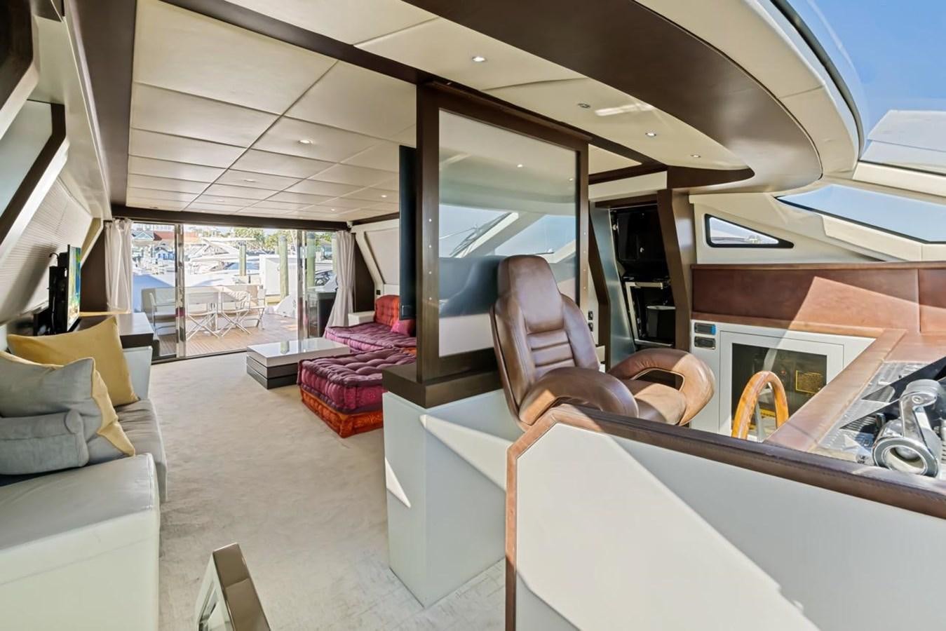 a person sitting in a chair in a room with a large window aboard DREAM ON Yacht for Sale