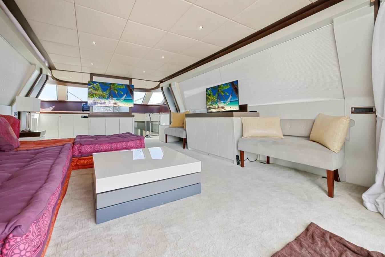a room with a couch and a tv on the wall aboard DREAM ON Yacht for Sale