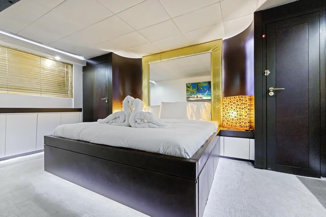 a room with a bed and a door aboard DREAM ON Yacht for Sale
