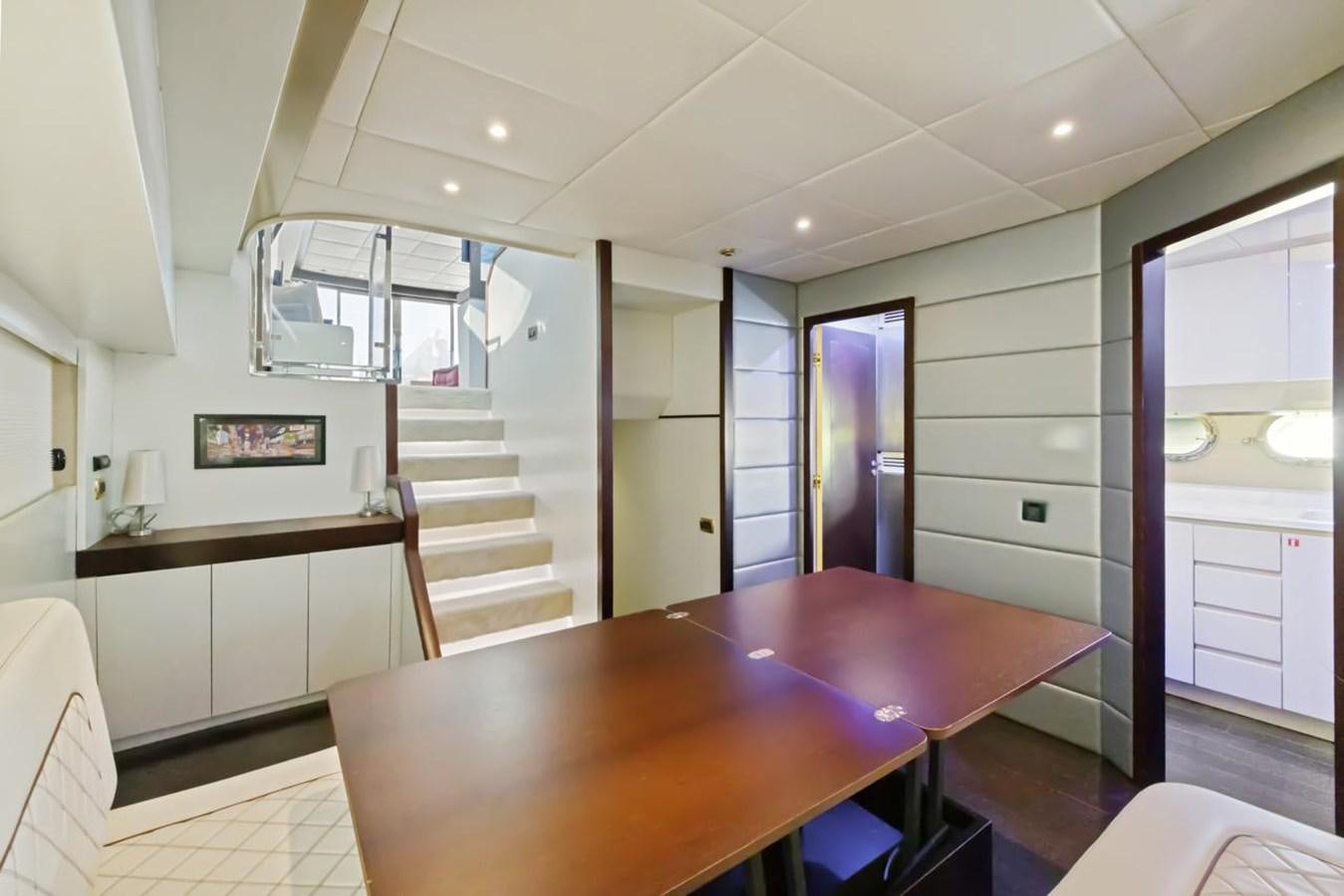 a kitchen with a table and chairs aboard DREAM ON Yacht for Sale