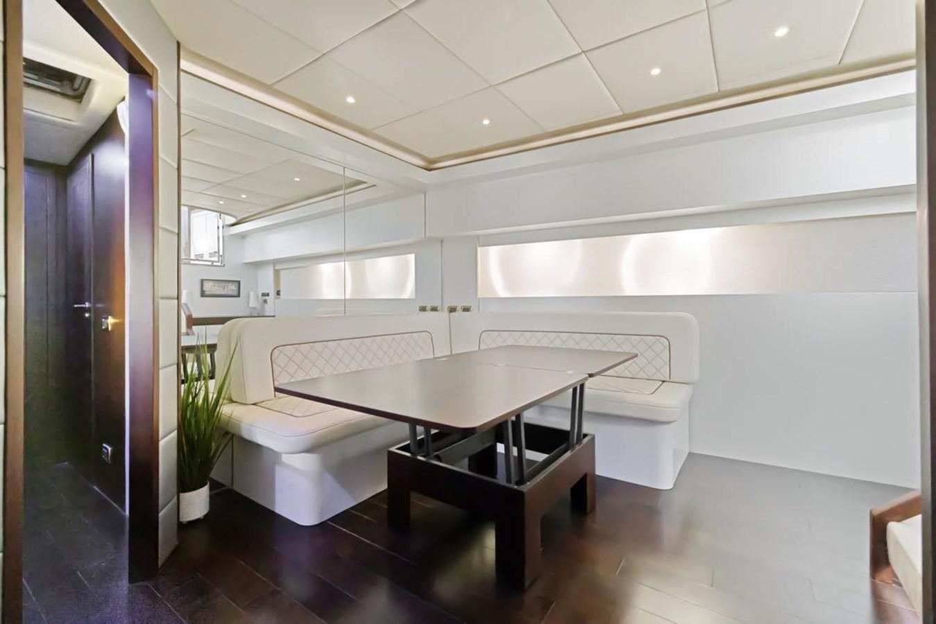 a room with a table and chairs aboard DREAM ON Yacht for Sale