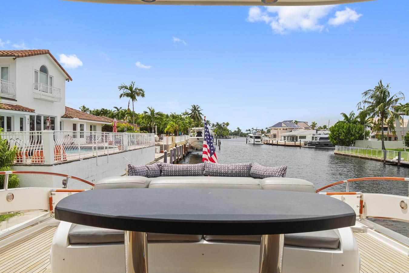 a deck with a flag on it and buildings in the background aboard LAZZARA 68' Yacht for Sale