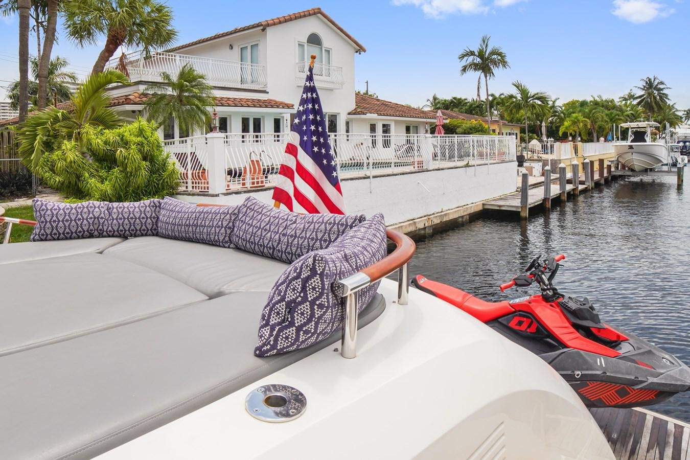 a boat with a flag on it aboard LAZZARA 68' Yacht for Sale