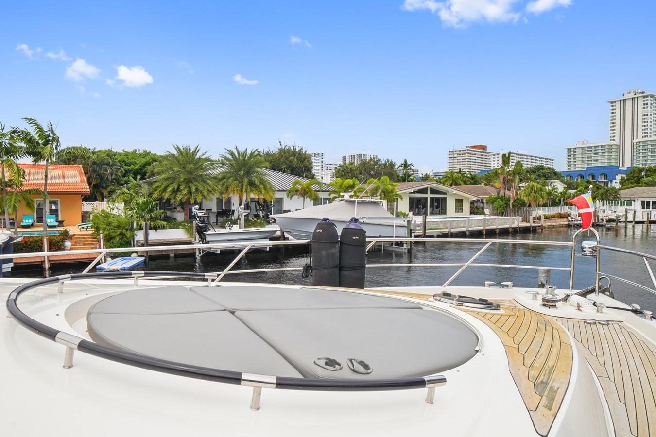 a pool with a large pool and buildings in the background aboard LAZZARA 68' Yacht for Sale