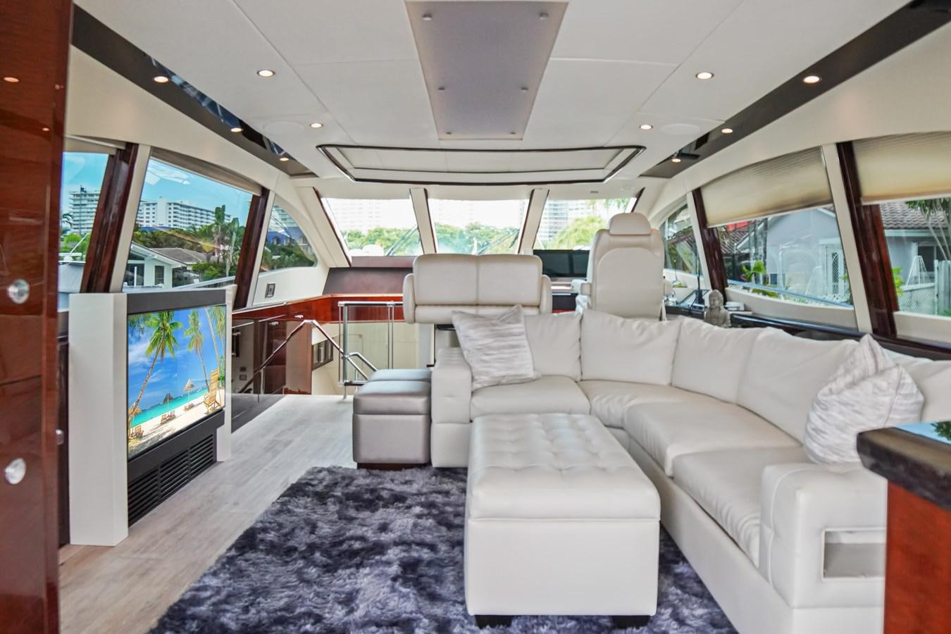 a large living room with a large screen aboard LAZZARA 68' Yacht for Sale