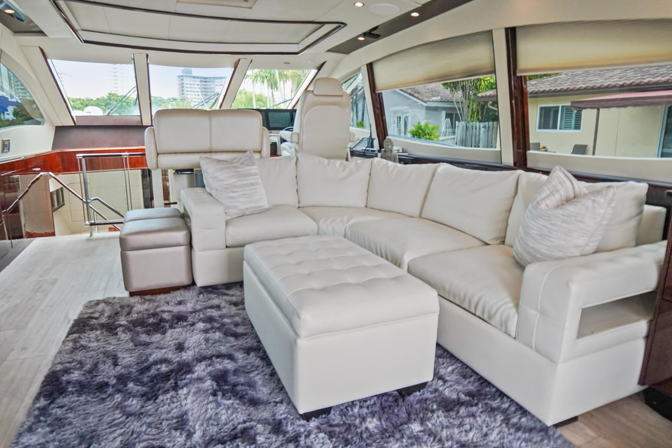 a white couch in a car aboard LAZZARA 68' Yacht for Sale