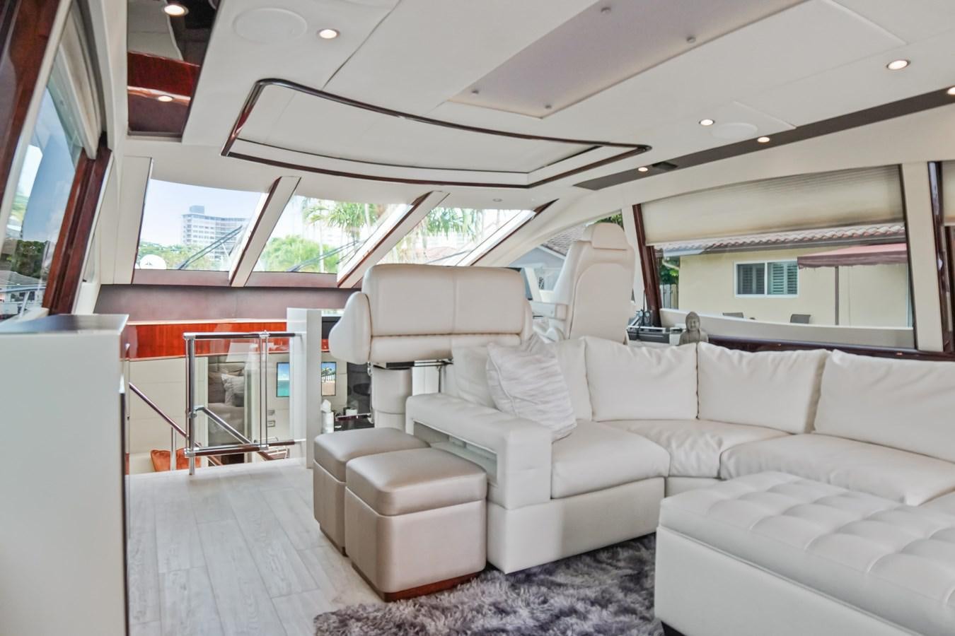 a living room with a couch aboard LAZZARA 68' Yacht for Sale
