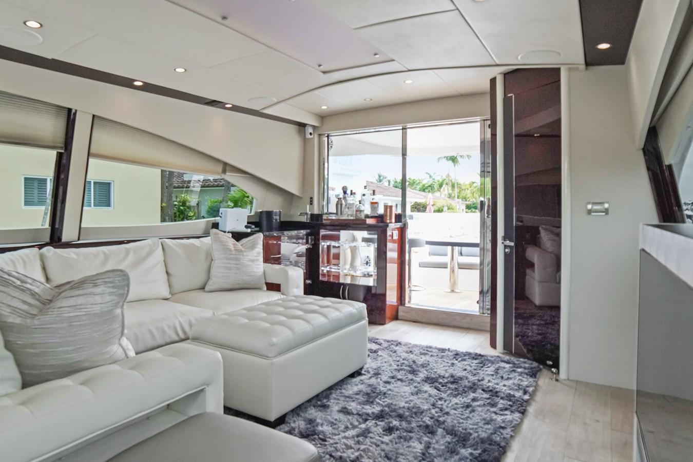 a living room with a large glass door aboard LAZZARA 68' Yacht for Sale