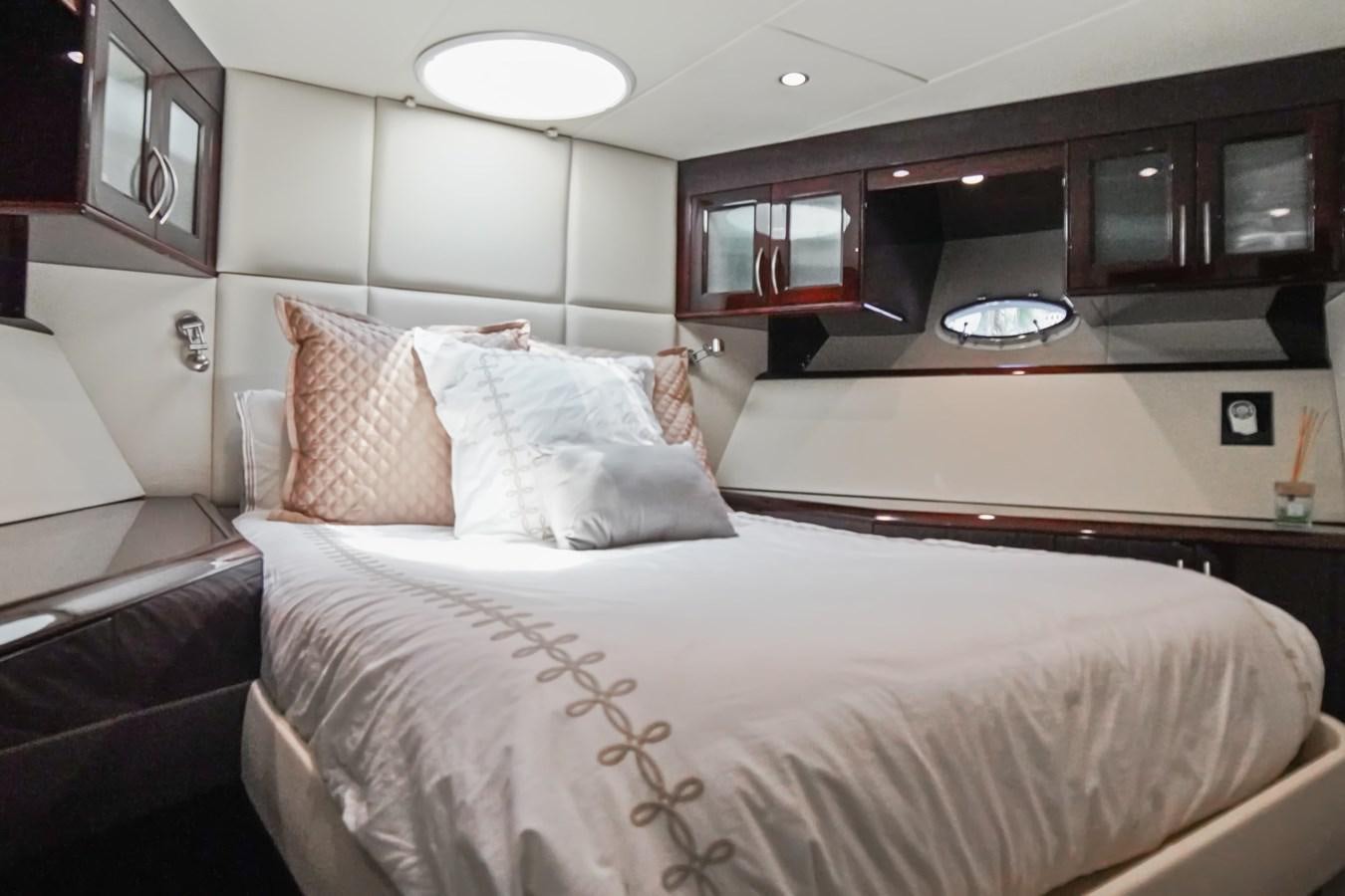 a bed with white sheets aboard LAZZARA 68' Yacht for Sale