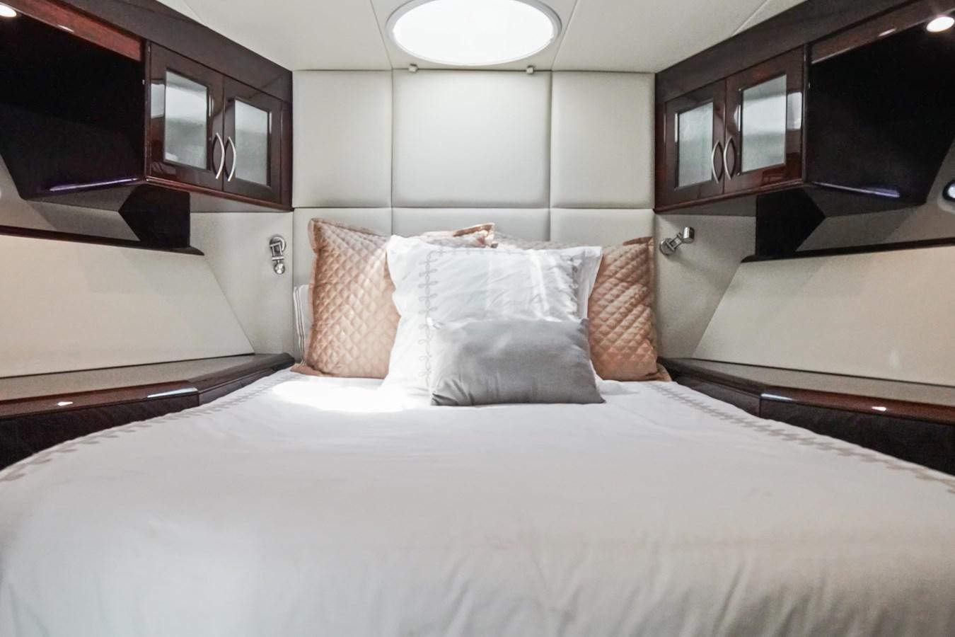 a bed with pillows aboard LAZZARA 68' Yacht for Sale