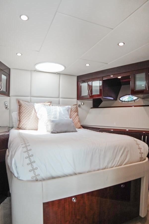 a room with a bed and a television aboard LAZZARA 68' Yacht for Sale