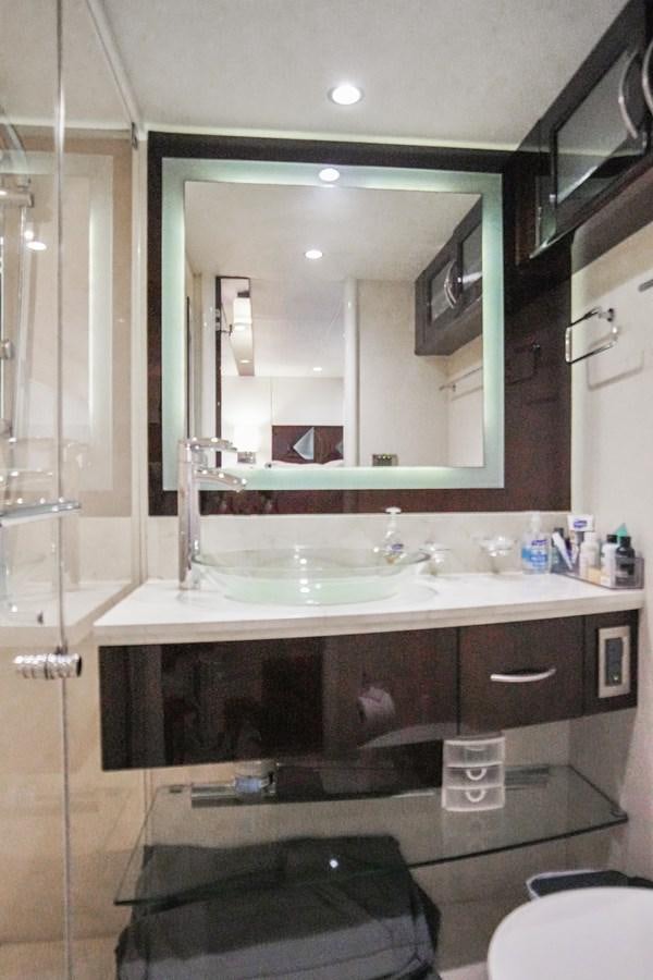 a bathroom with a large mirror aboard LAZZARA 68' Yacht for Sale