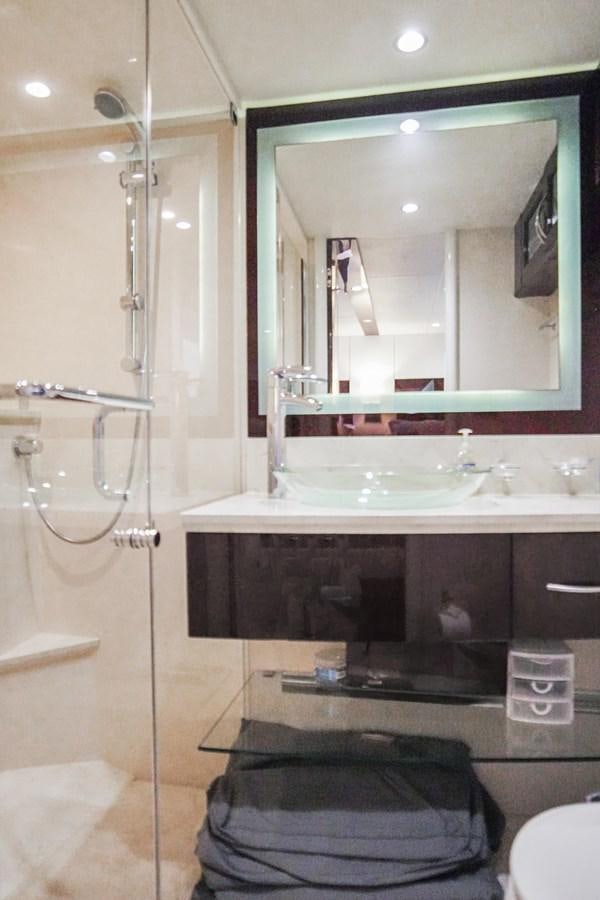 a bathroom with a large mirror aboard LAZZARA 68' Yacht for Sale