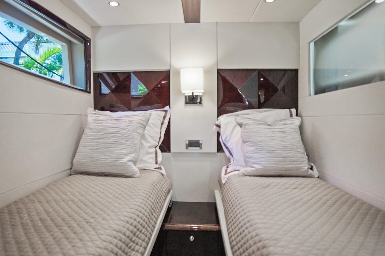 a room with two beds aboard LAZZARA 68' Yacht for Sale