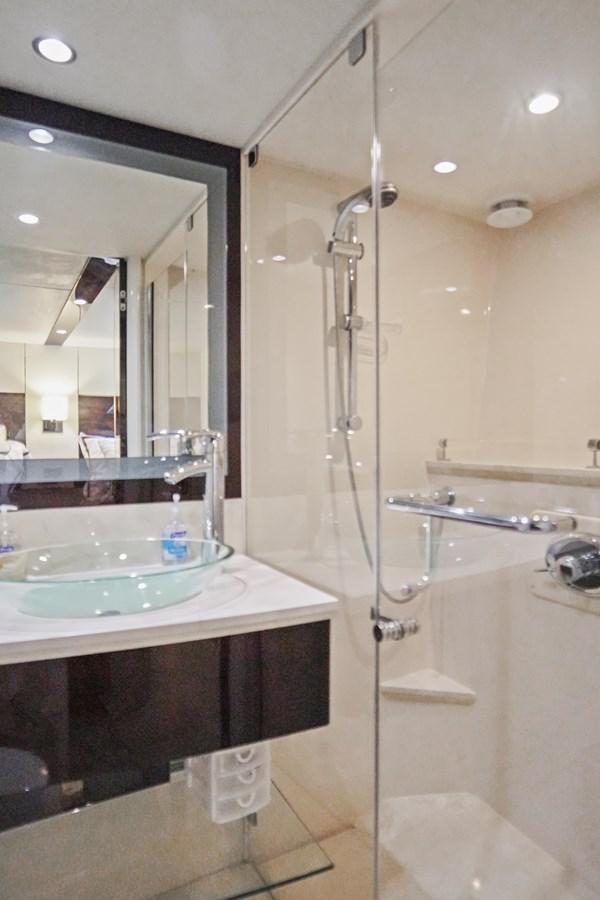 a bathroom with a glass shower aboard LAZZARA 68' Yacht for Sale