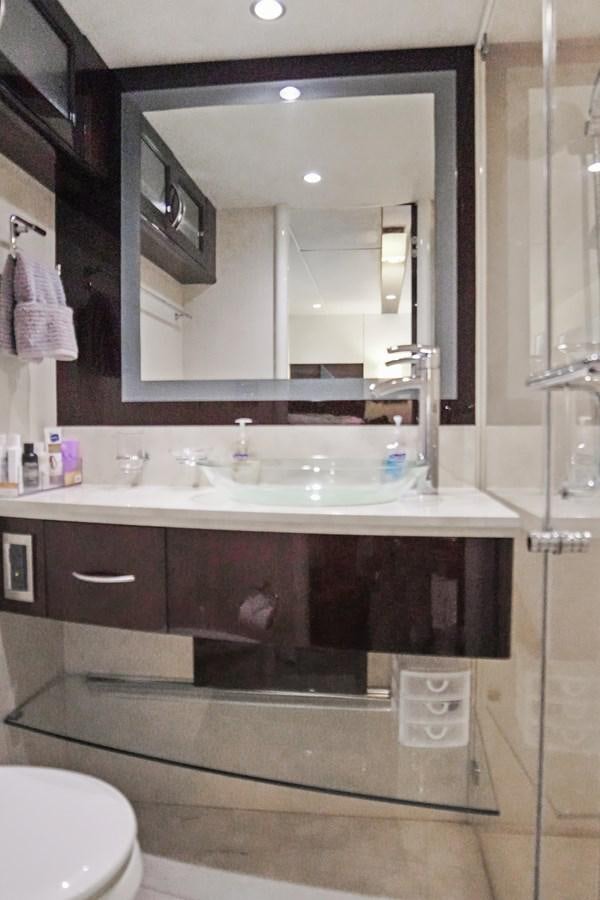 a bathroom with a large mirror aboard LAZZARA 68' Yacht for Sale