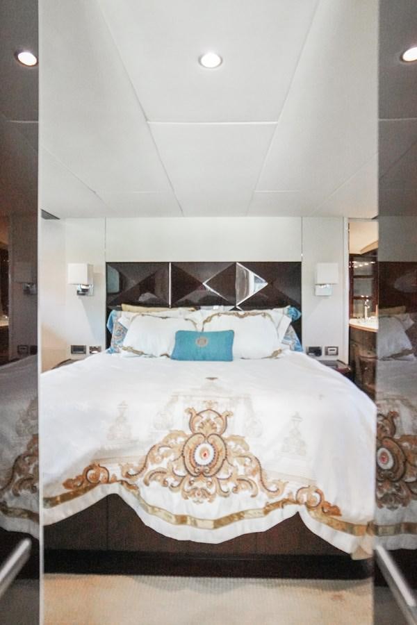 a bed with a pillow and a headboard aboard LAZZARA 68' Yacht for Sale