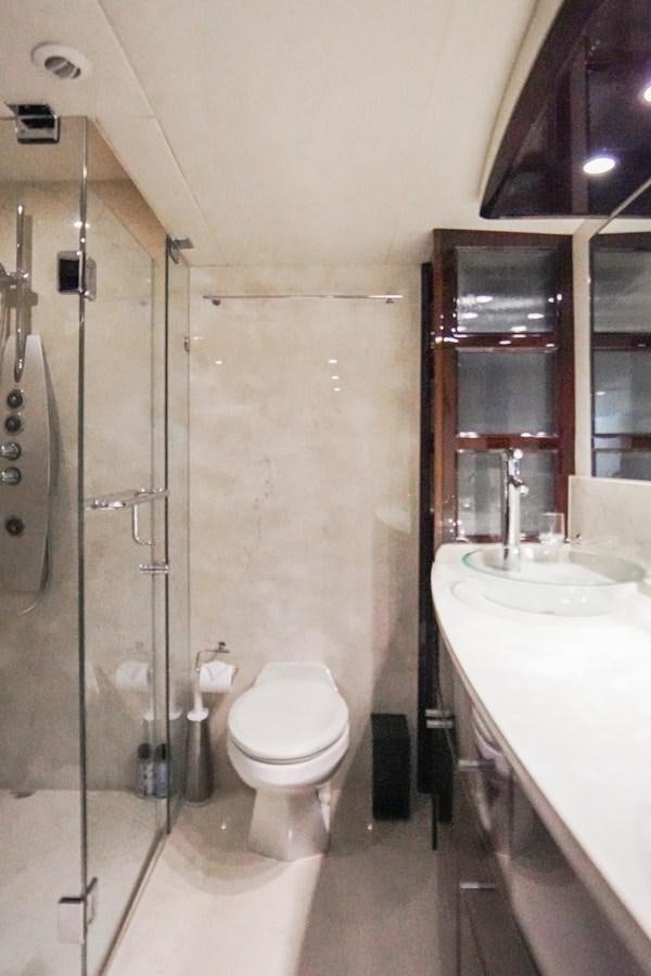 a bathroom with a glass shower aboard LAZZARA 68' Yacht for Sale