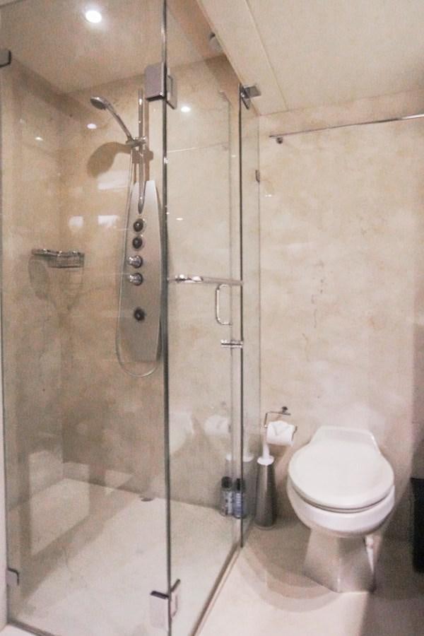 a bathroom with a glass shower aboard LAZZARA 68' Yacht for Sale