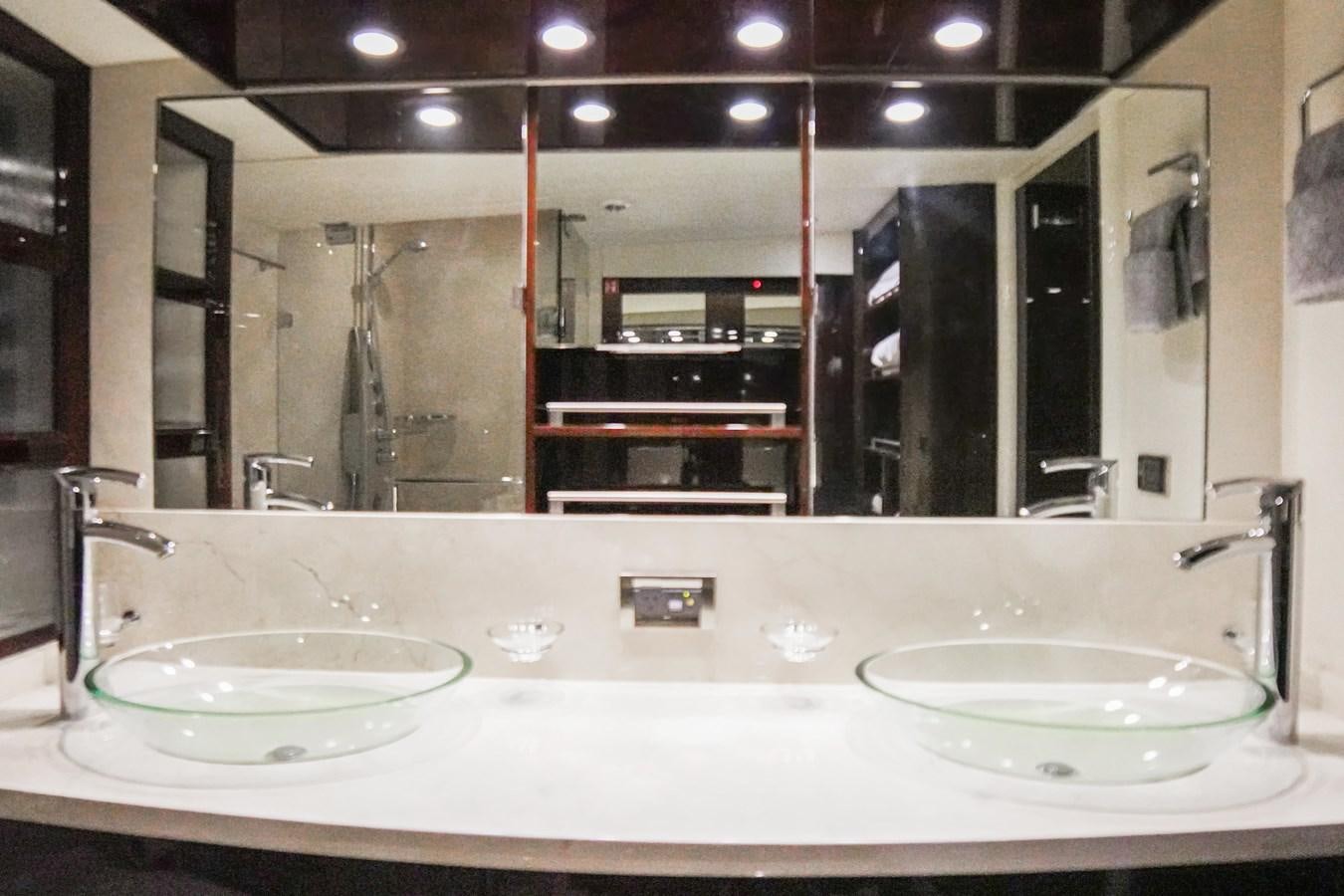 a bathroom with sinks and mirrors aboard LAZZARA 68' Yacht for Sale