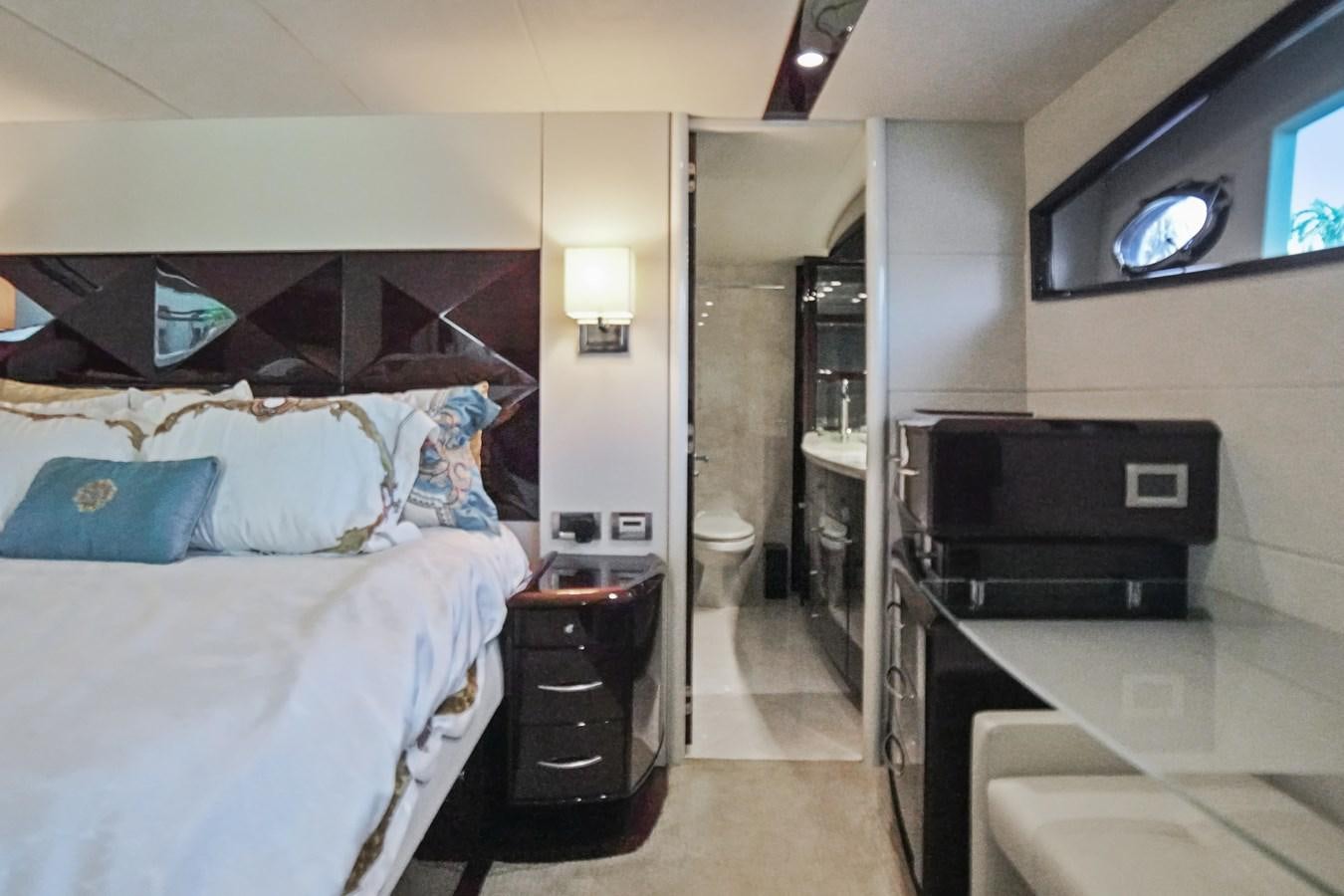 a bedroom with a bed and a television aboard LAZZARA 68' Yacht for Sale
