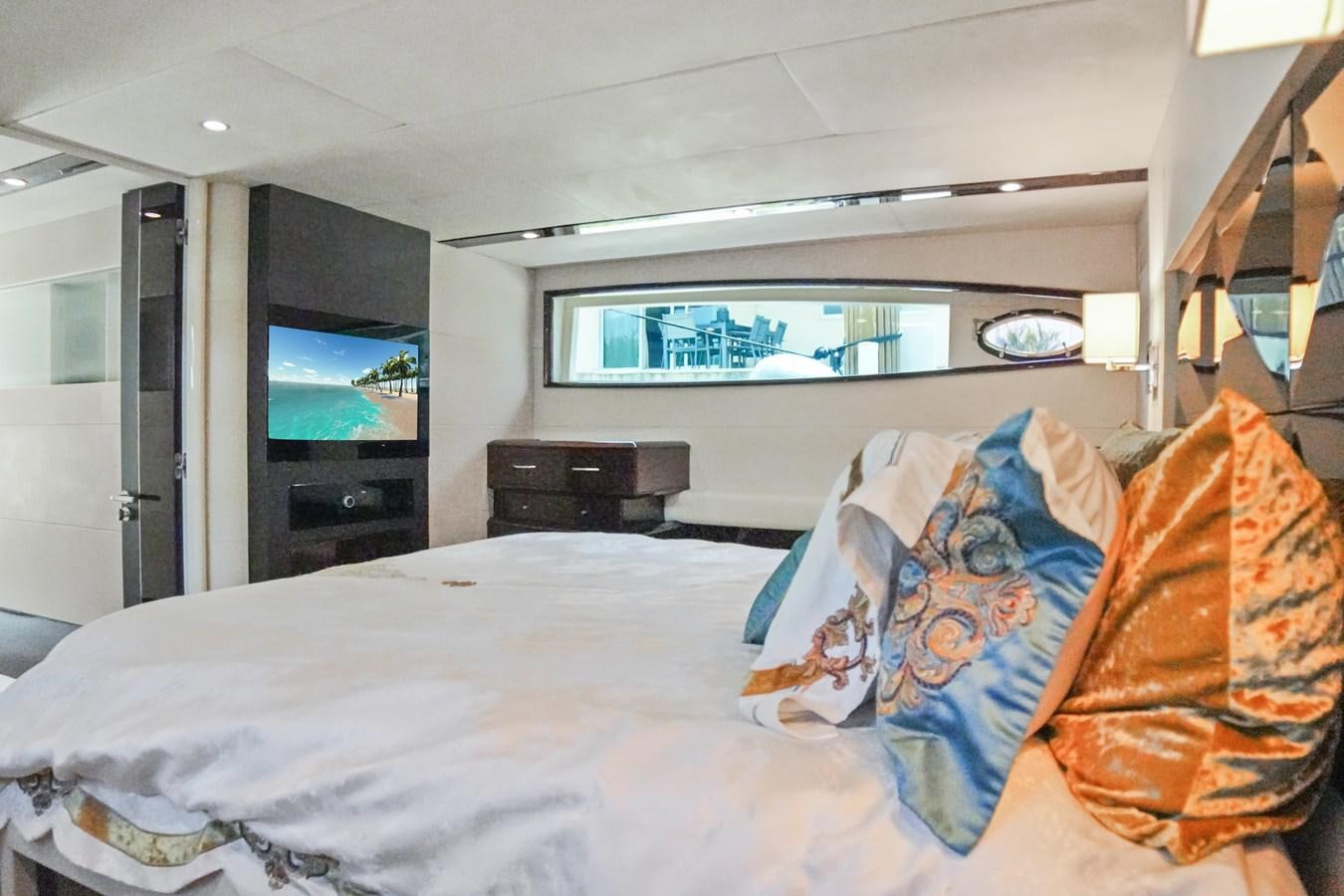 a bedroom with a large television aboard LAZZARA 68' Yacht for Sale