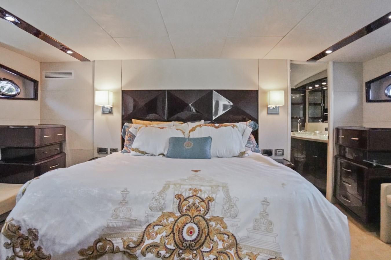 a bedroom with a large bed aboard LAZZARA 68' Yacht for Sale