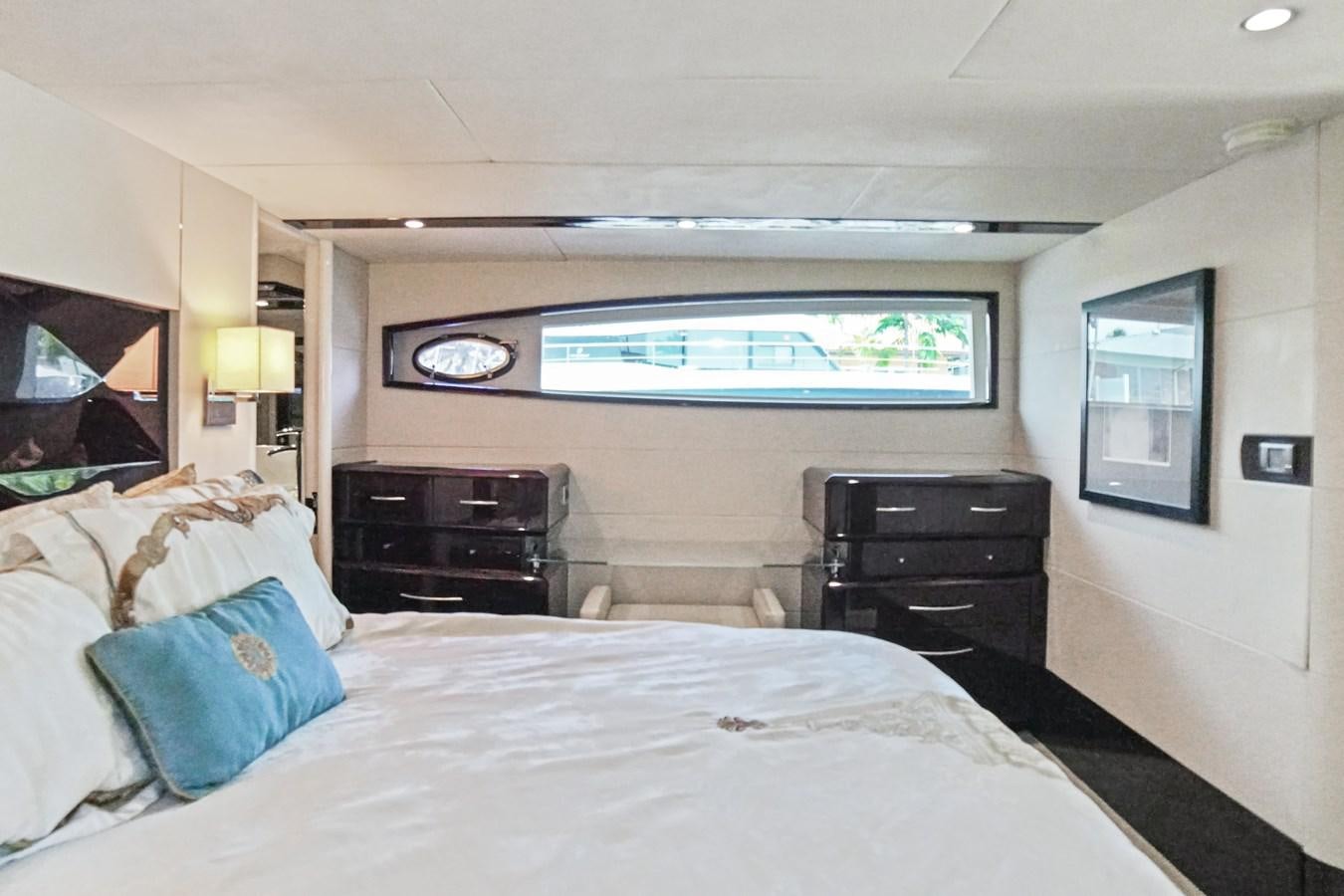 a bedroom with a large bed and a flat screen tv aboard LAZZARA 68' Yacht for Sale