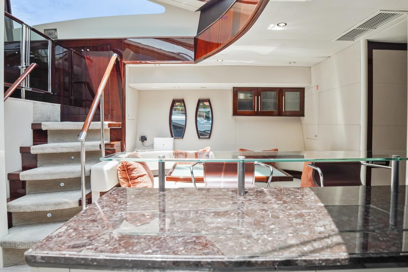 a room with a table and chairs aboard LAZZARA 68' Yacht for Sale