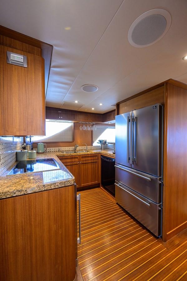 a kitchen with a stainless steel refrigerator aboard ST. TROPEZ Yacht for Sale