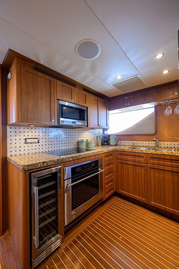 a kitchen with wooden cabinets aboard ST. TROPEZ Yacht for Sale