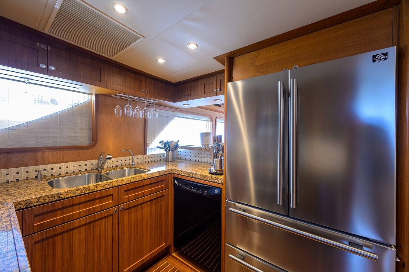 a kitchen with a stainless steel refrigerator aboard ST. TROPEZ Yacht for Sale