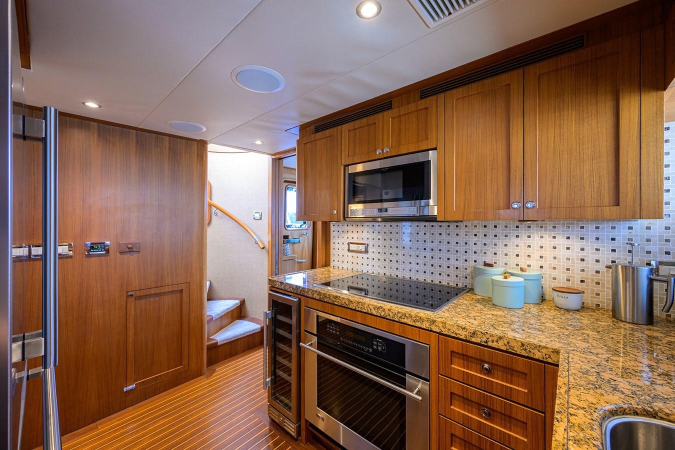 a kitchen with wooden cabinets aboard ST. TROPEZ Yacht for Sale