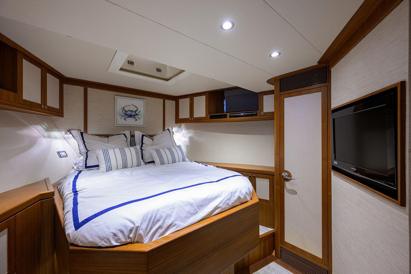 a bedroom with a bed and a television aboard ST. TROPEZ Yacht for Sale