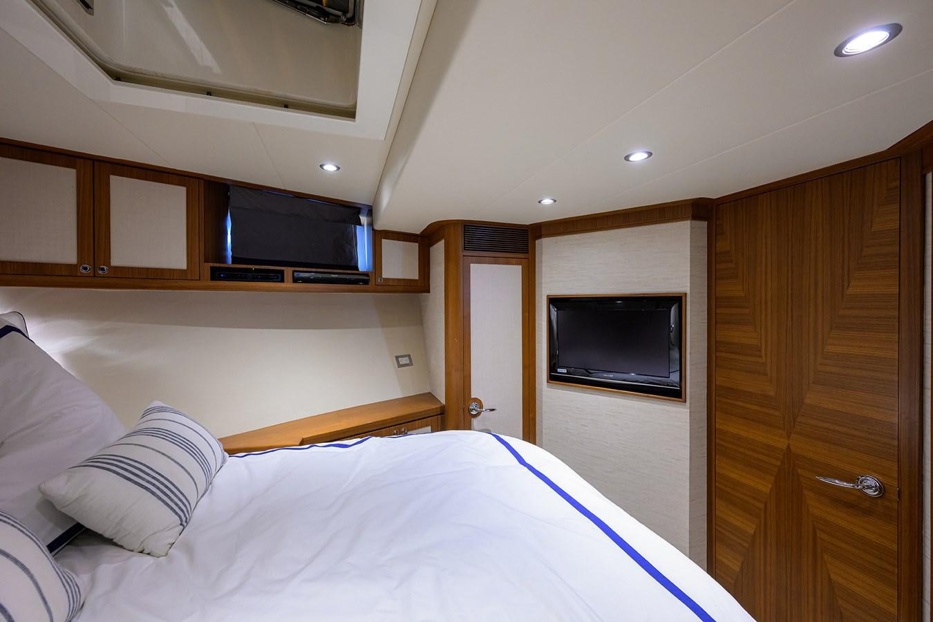 a bedroom with a bed and a television aboard ST. TROPEZ Yacht for Sale