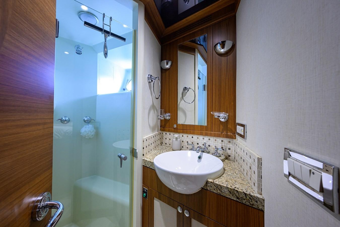 a bathroom with a sink and a shower aboard ST. TROPEZ Yacht for Sale