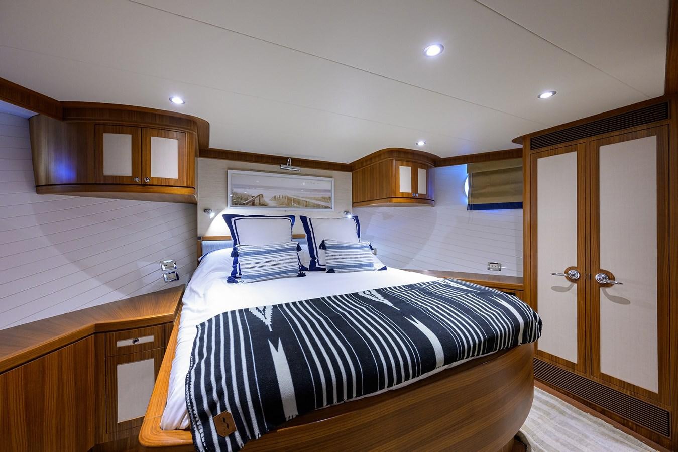 a bedroom with a bed and cabinets aboard ST. TROPEZ Yacht for Sale