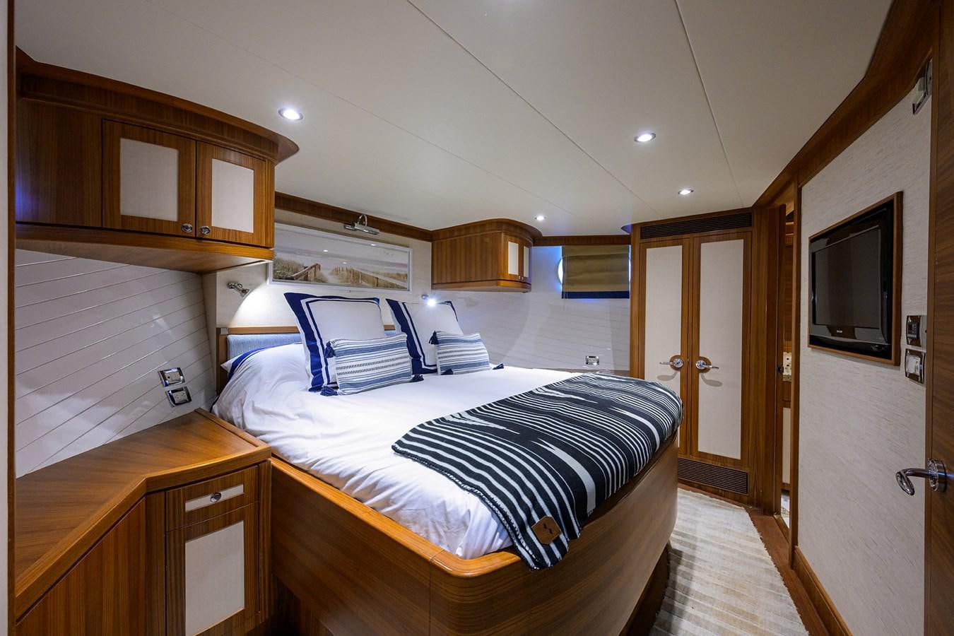 a bedroom with a bed and a desk aboard ST. TROPEZ Yacht for Sale
