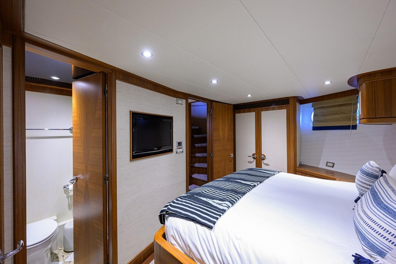 a bedroom with a bed and a television aboard ST. TROPEZ Yacht for Sale