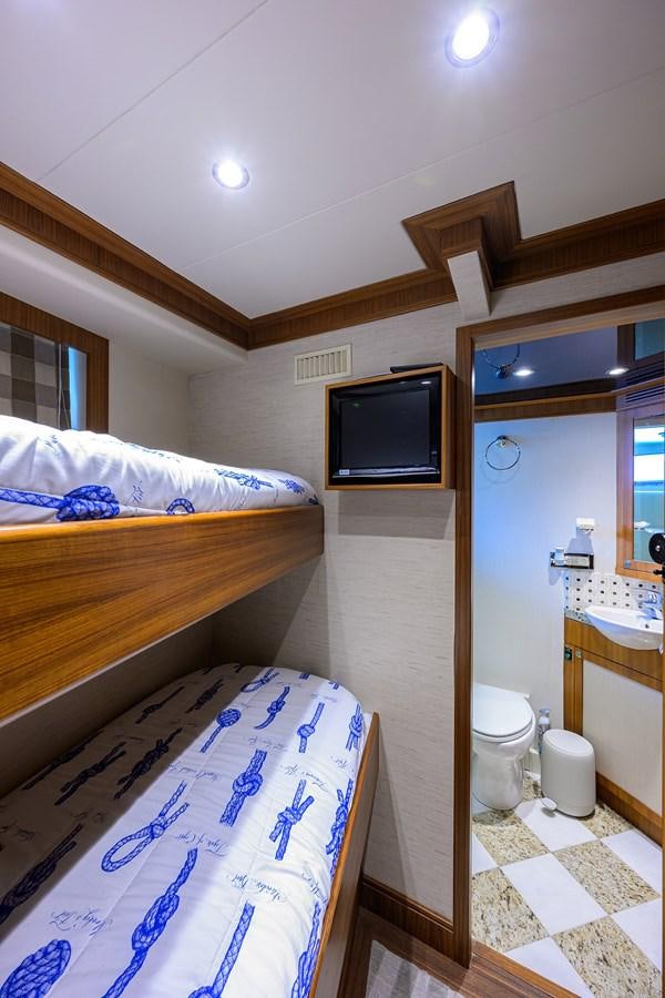 a small bedroom with a small tv aboard ST. TROPEZ Yacht for Sale