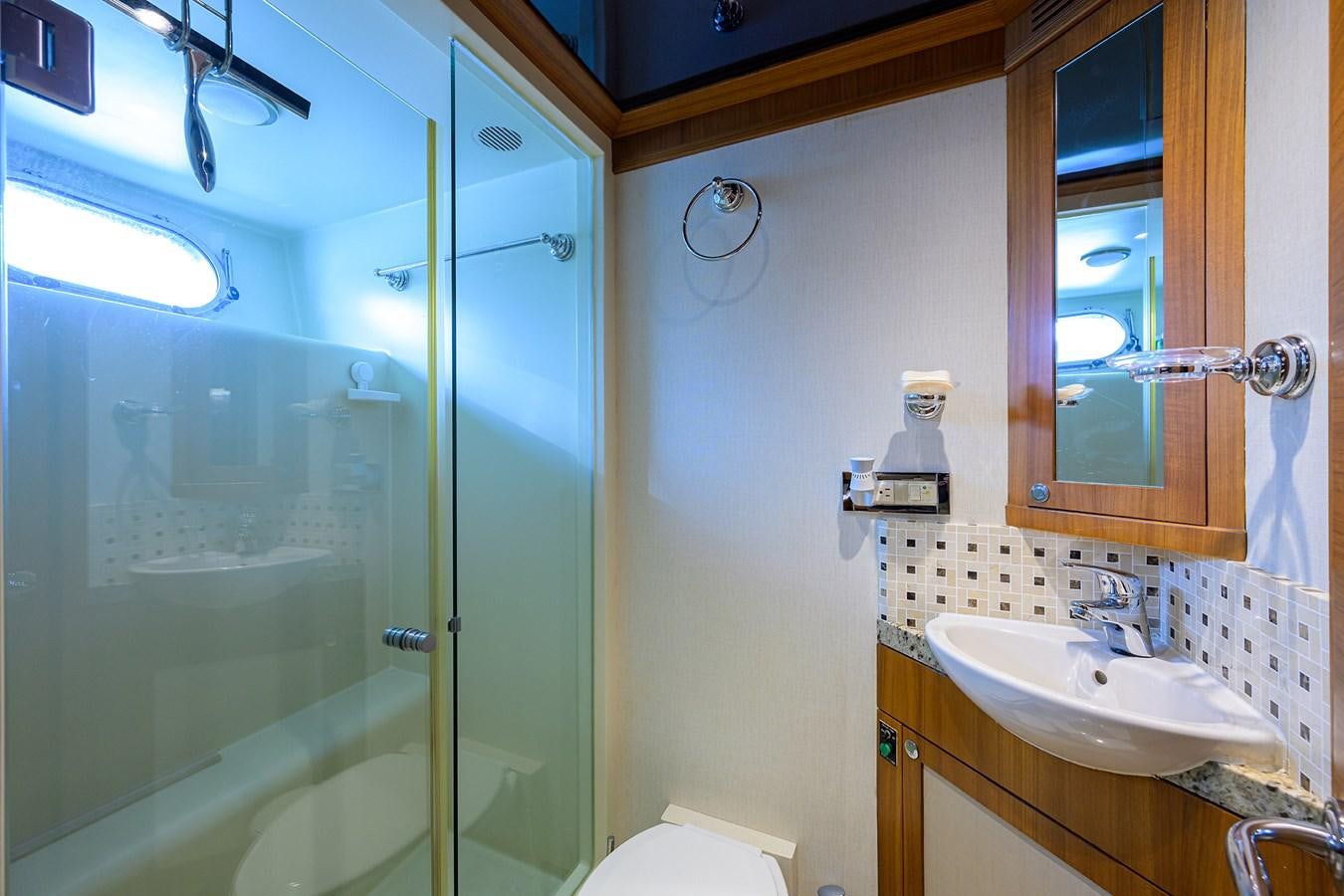 a bathroom with a glass shower door aboard ST. TROPEZ Yacht for Sale