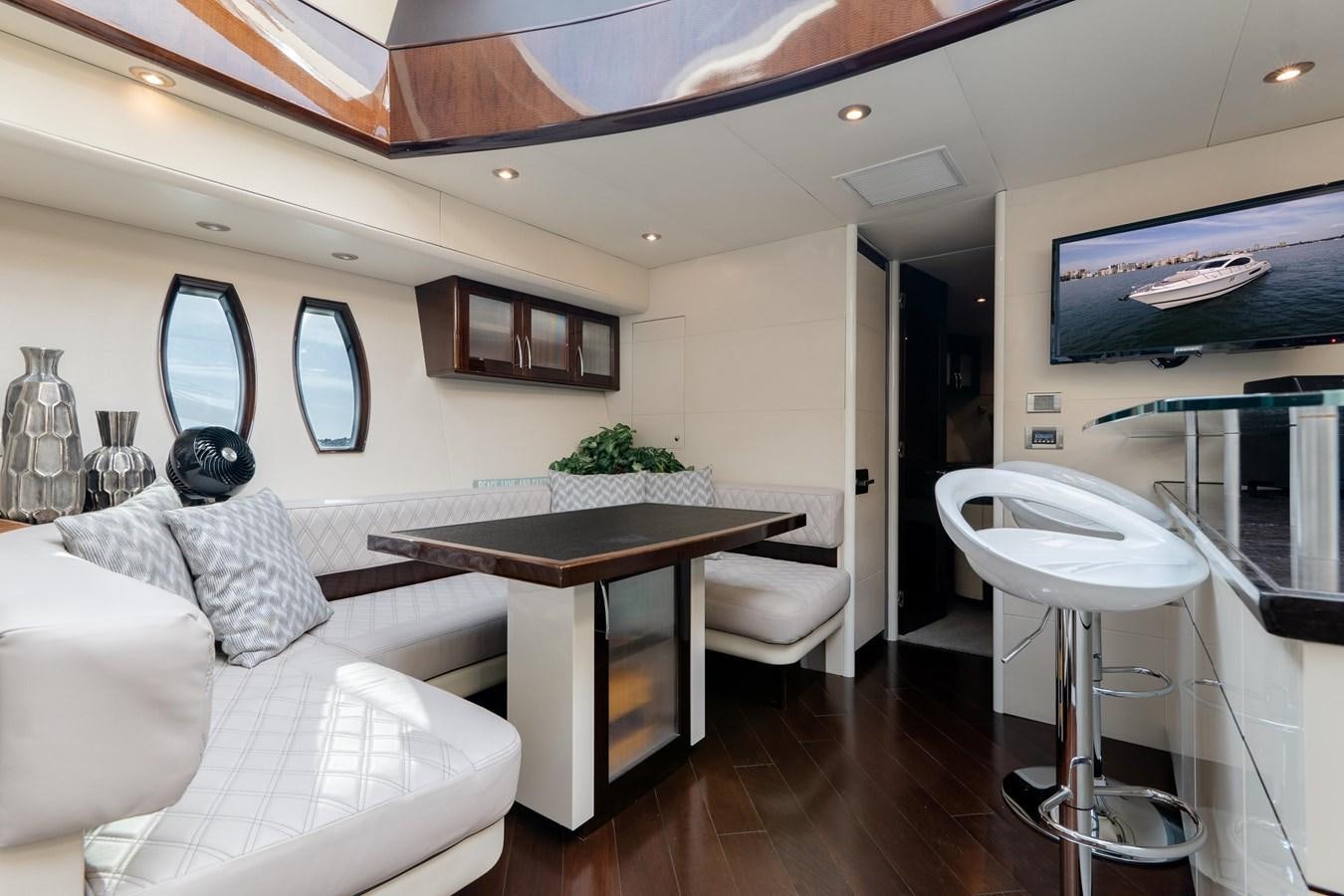 a living room with a table and couches aboard SALACIA Yacht for Sale