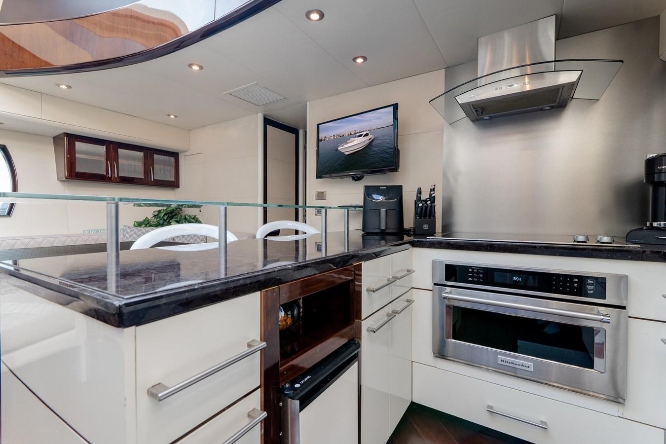 a kitchen with a large tv aboard SALACIA Yacht for Sale