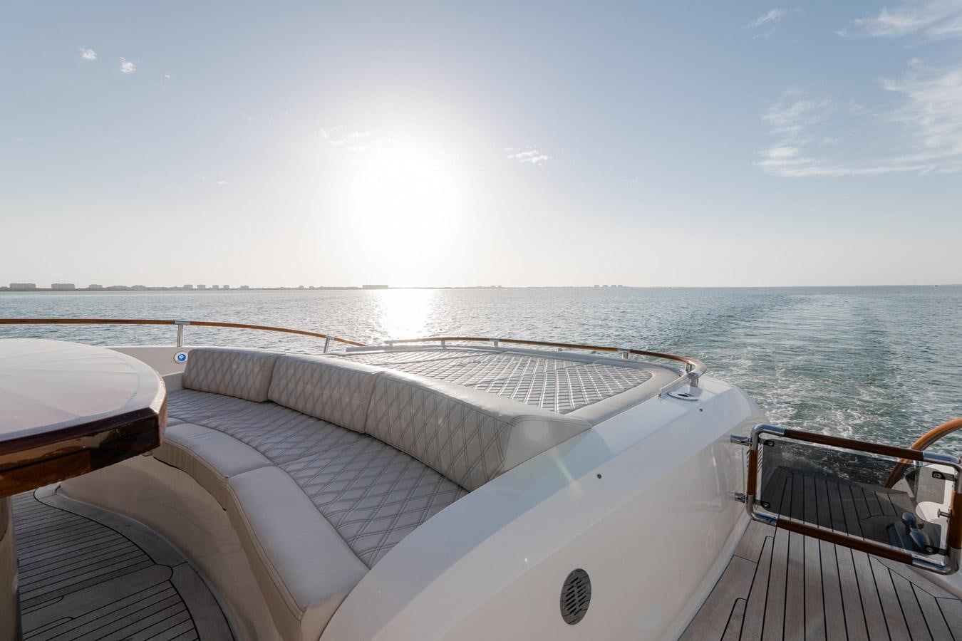 a deck with a view of the ocean and the sun aboard SALACIA Yacht for Sale