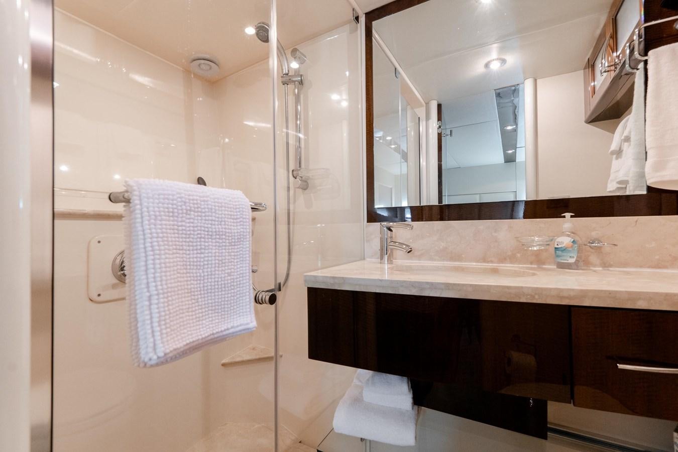 a bathroom with a shower sink and mirror aboard SALACIA Yacht for Sale