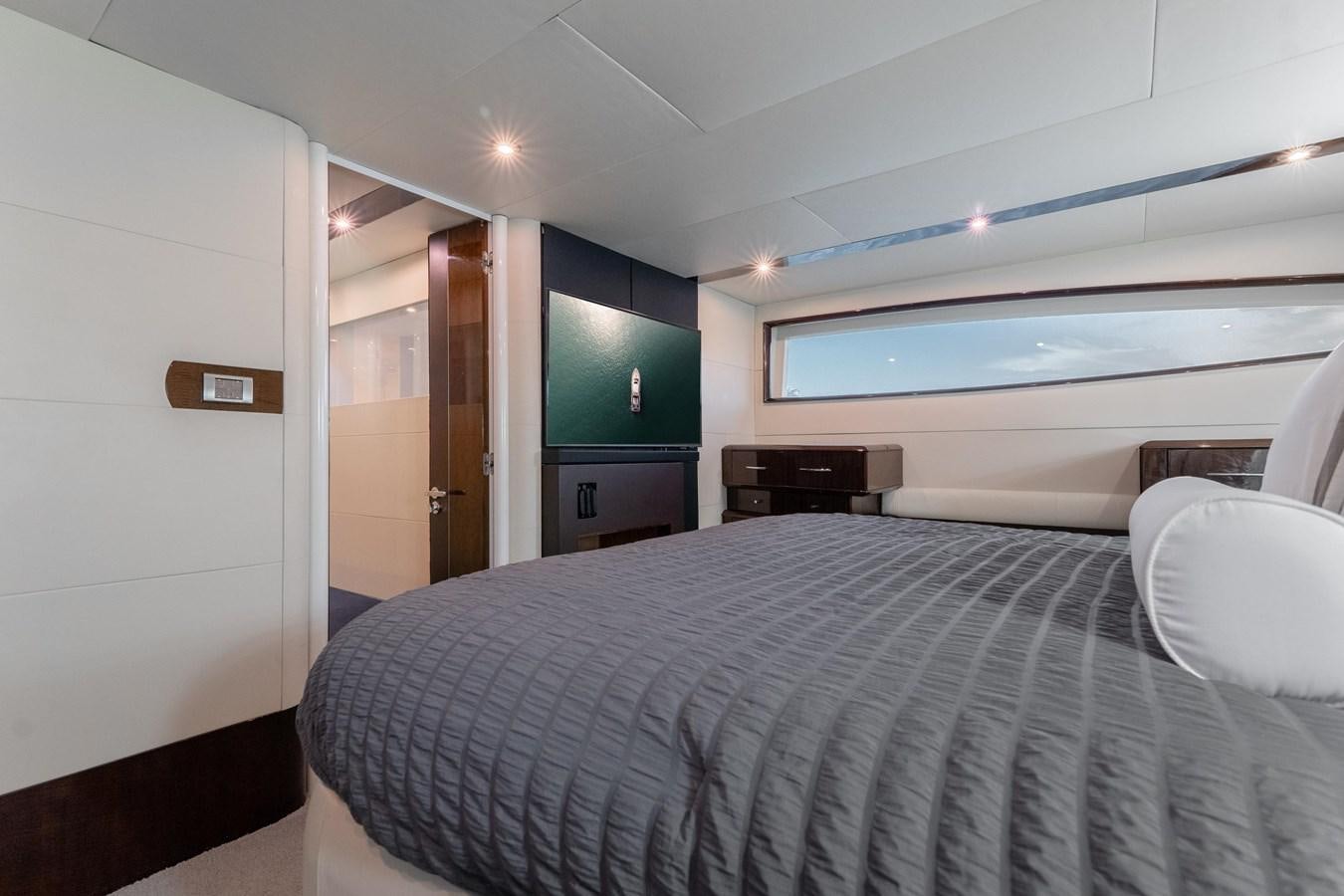 a bedroom with a bed and a television aboard SALACIA Yacht for Sale