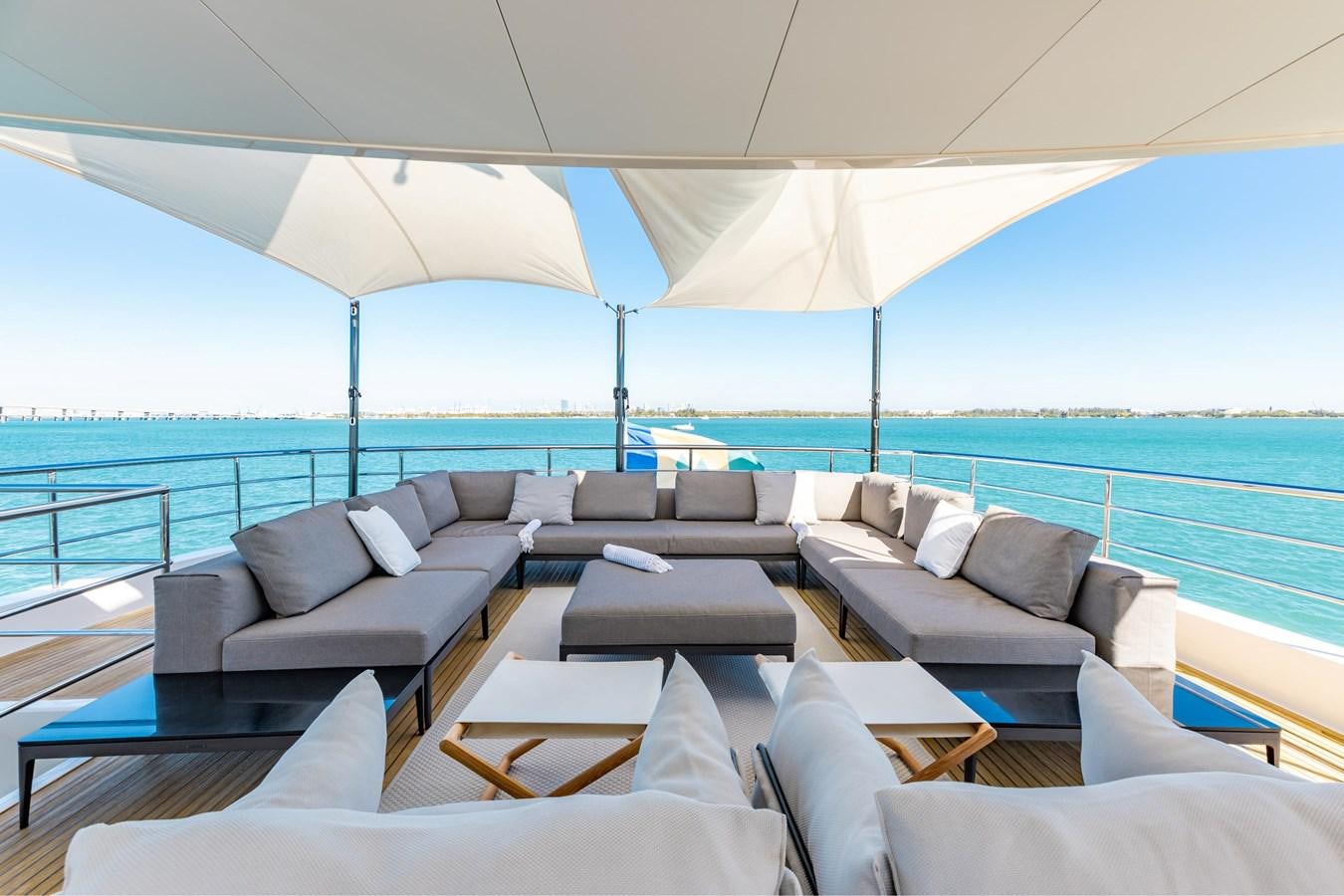 a large living room with a large blue ocean aboard ADAGIO Yacht for Sale